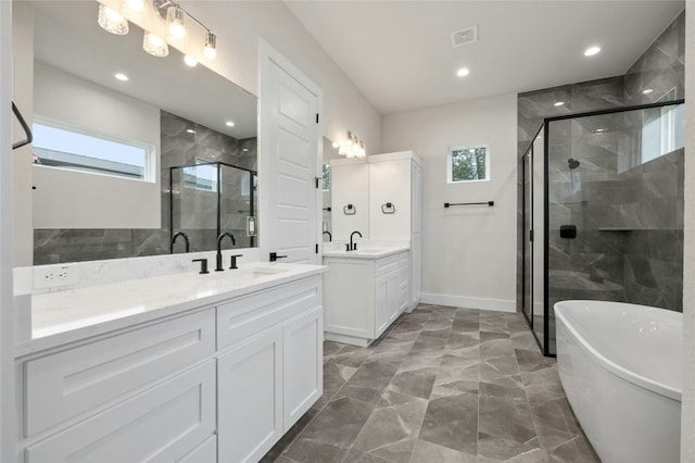 bathroom with vanity and separate shower and tub