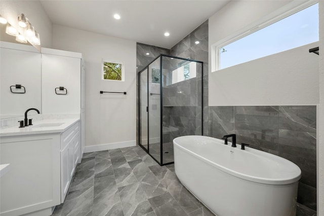 bathroom featuring vanity and shower with separate bathtub