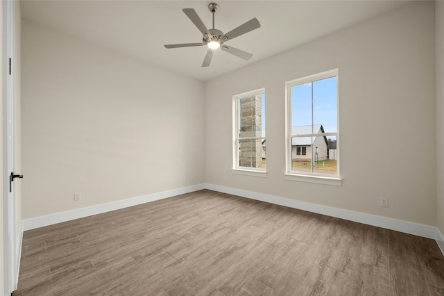 unfurnished room with light hardwood / wood-style flooring and ceiling fan