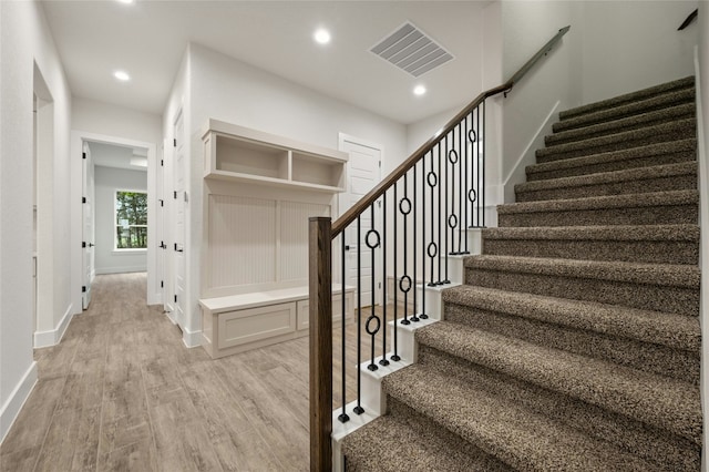 stairway with hardwood / wood-style flooring