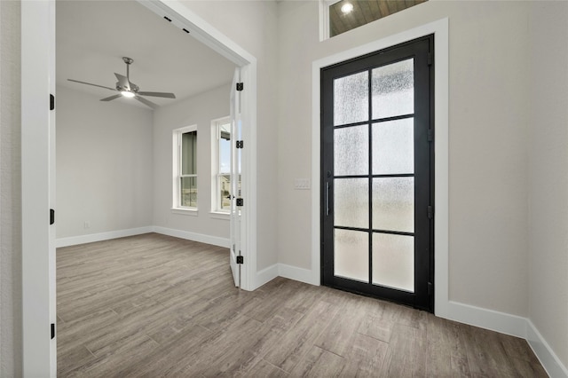 foyer entrance featuring ceiling fan and light wood-type flooring