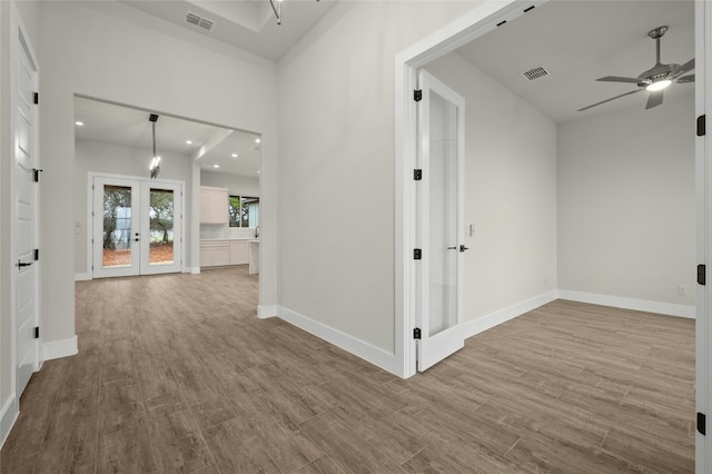 hall featuring french doors and light hardwood / wood-style flooring