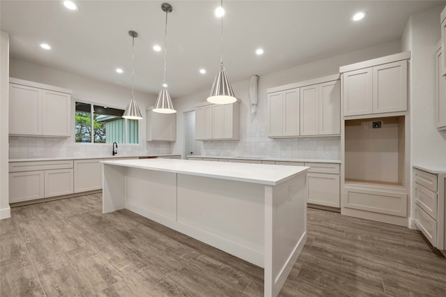 kitchen featuring white cabinetry, light hardwood / wood-style floors, and a kitchen island