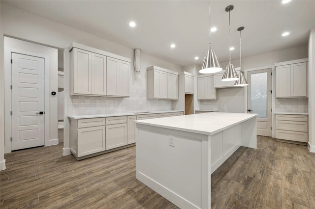 kitchen with white cabinetry, dark hardwood / wood-style flooring, and a center island