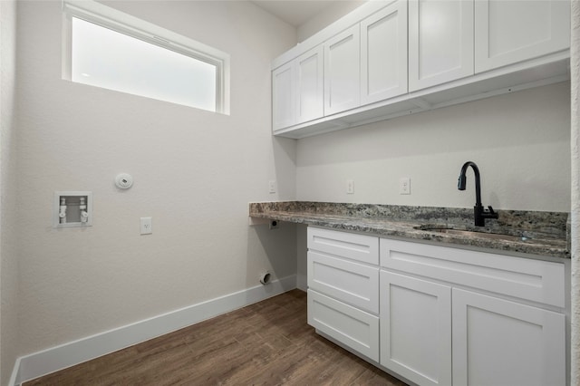 laundry room with cabinets, dark hardwood / wood-style flooring, sink, and electric dryer hookup