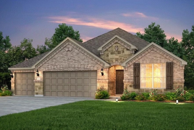 view of front facade with a garage and a yard