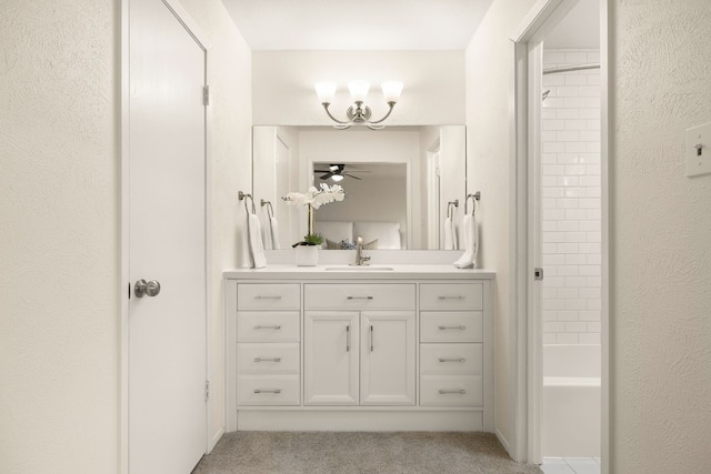 bathroom featuring vanity and tiled shower / bath