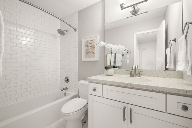 full bathroom with tiled shower / bath, vanity, and toilet