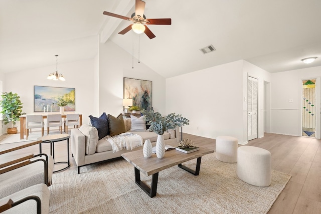 living room featuring ceiling fan with notable chandelier, high vaulted ceiling, beam ceiling, and light hardwood / wood-style floors