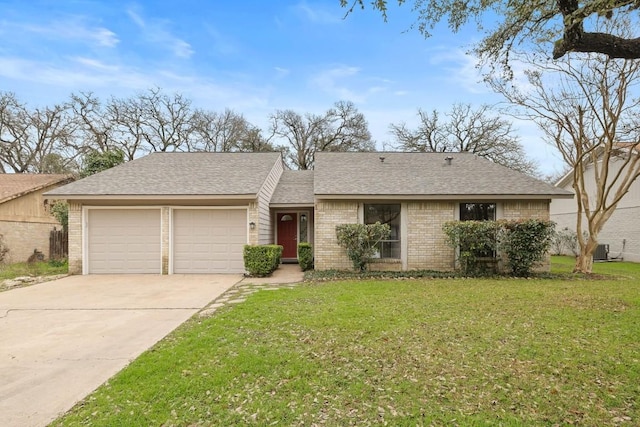 ranch-style house with central AC unit, a garage, and a front yard