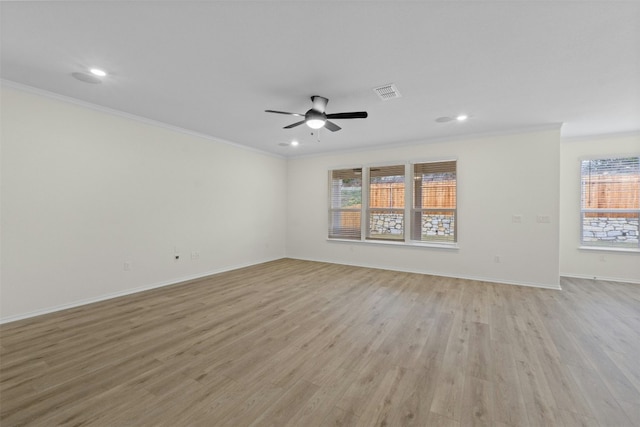 spare room with light hardwood / wood-style flooring, ornamental molding, and ceiling fan