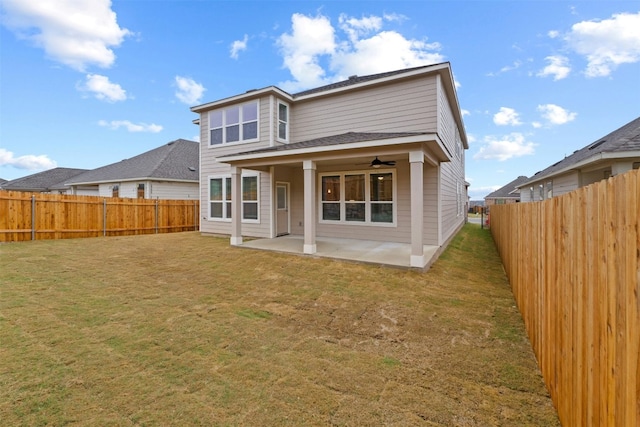 rear view of property with a patio, ceiling fan, and a lawn