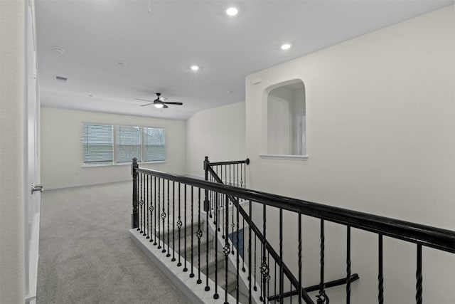 hallway with light colored carpet