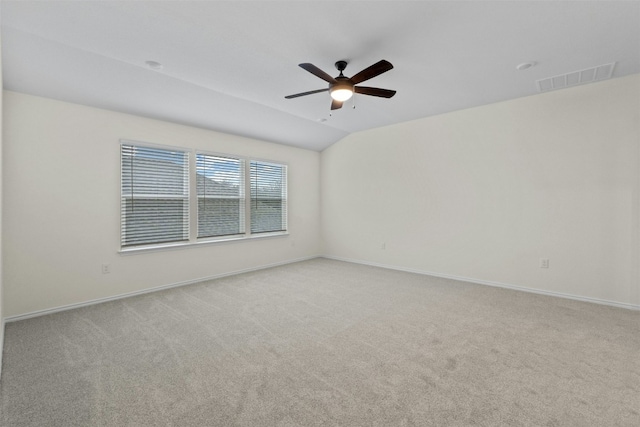 carpeted spare room with ceiling fan and lofted ceiling