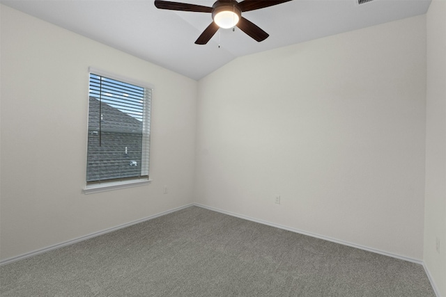 carpeted empty room with vaulted ceiling and ceiling fan