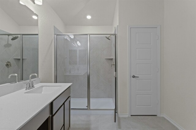 bathroom featuring vanity, an enclosed shower, and tile patterned flooring