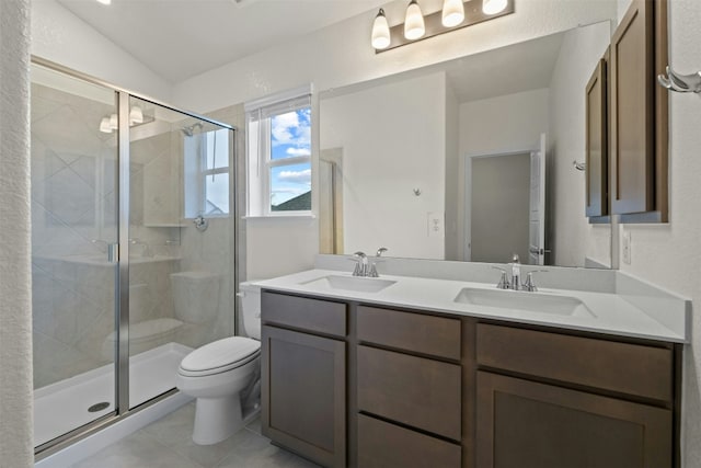 bathroom featuring an enclosed shower, vanity, tile patterned flooring, and toilet