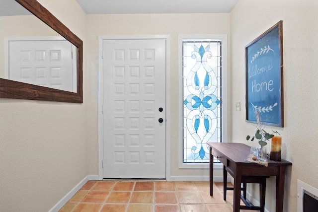 foyer entrance with light tile patterned floors