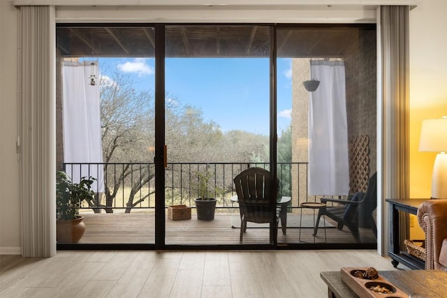 entryway with expansive windows and wood finished floors