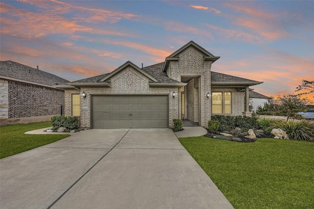 view of front of home featuring a garage and a lawn