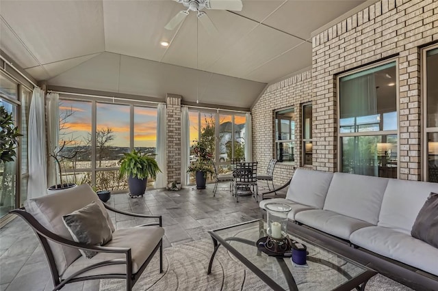 sunroom featuring ceiling fan and lofted ceiling