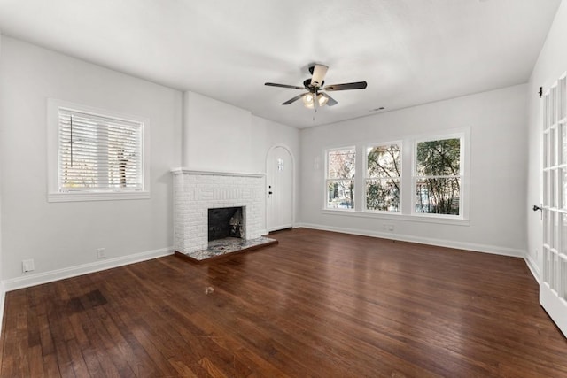 unfurnished living room featuring ceiling fan, dark wood-type flooring, and a fireplace