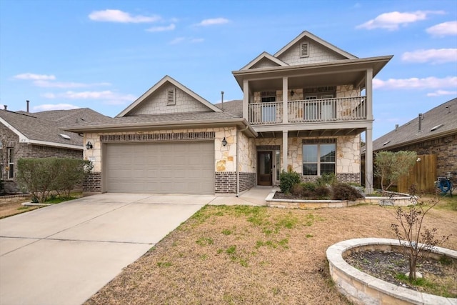 view of front of property featuring a garage and a balcony