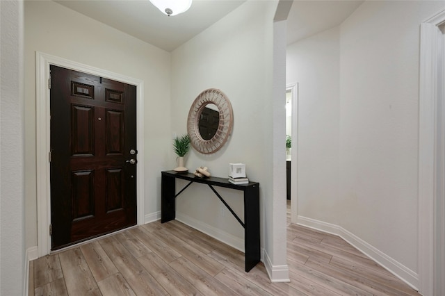 foyer entrance with light hardwood / wood-style floors