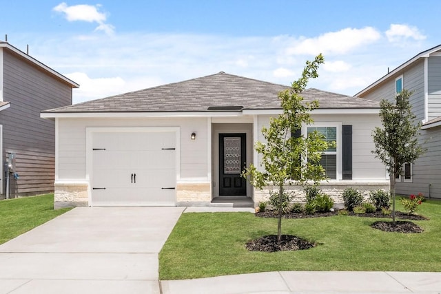 view of front of property featuring a garage and a front lawn