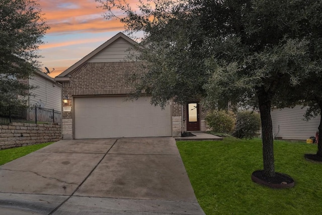10017 Pinnacle Crest Loop, Austin, TX 78747 - view of front facade with brick siding, driveway, and an attached garage