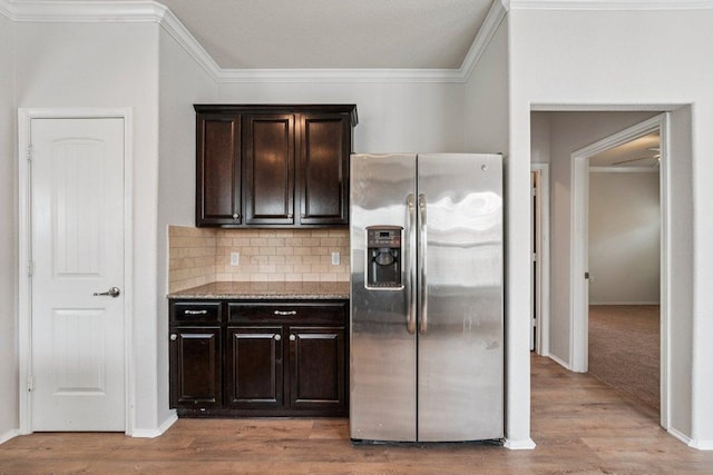10017 Pinnacle Crest Loop, Austin, TX 78747 - kitchen featuring stainless steel fridge, dark brown cabinets, crown molding, decorative backsplash, and light wood-type flooring