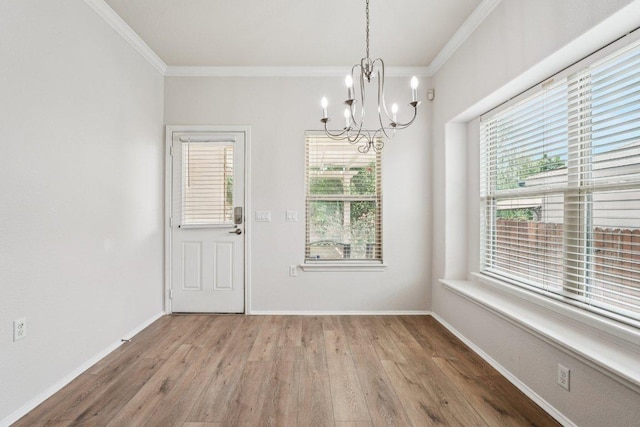 10017 Pinnacle Crest Loop, Austin, TX 78747 - unfurnished dining area with ornamental molding, a chandelier, wood finished floors, plenty of natural light, and baseboards