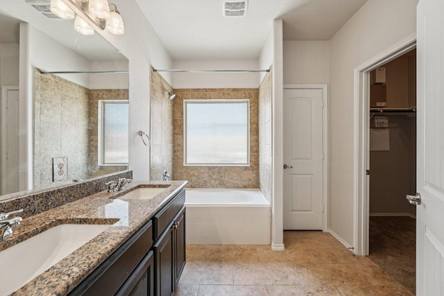 10017 Pinnacle Crest Loop, Austin, TX 78747 - bathroom with double vanity, a closet, and shower / bathtub combination