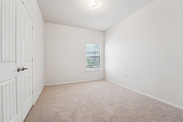 10017 Pinnacle Crest Loop, Austin, TX 78747 - unfurnished bedroom with light carpet, baseboards, and a closet