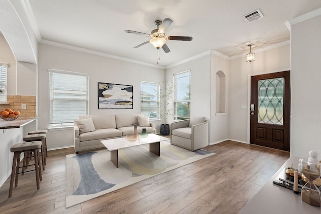 10017 Pinnacle Crest Loop, Austin, TX 78747 - living room with hardwood / wood-style floors, ornamental molding, ceiling fan, baseboards, and arched walkways