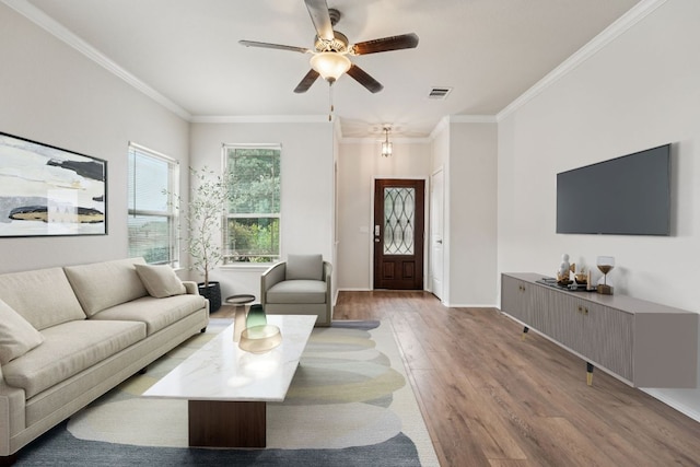 10017 Pinnacle Crest Loop, Austin, TX 78747 - living area featuring wood finished floors, a ceiling fan, ornamental molding, and baseboards