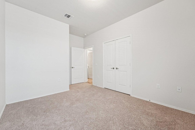 10017 Pinnacle Crest Loop, Austin, TX 78747 - unfurnished bedroom featuring light carpet and a closet