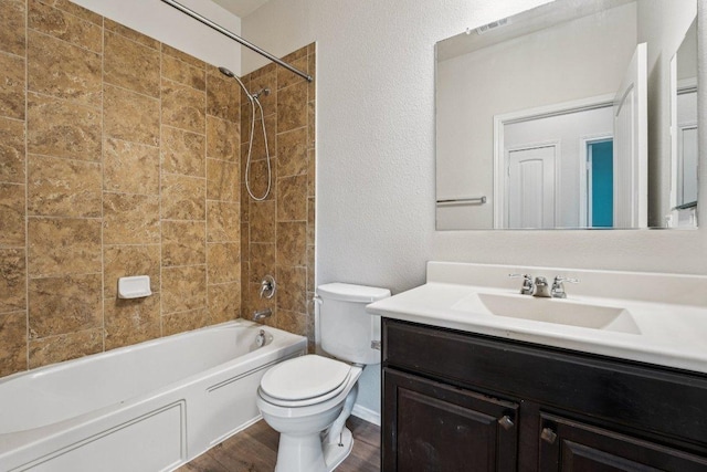 10017 Pinnacle Crest Loop, Austin, TX 78747 - bathroom featuring vanity, toilet, bathtub / shower combination, wood finished floors, and a textured wall