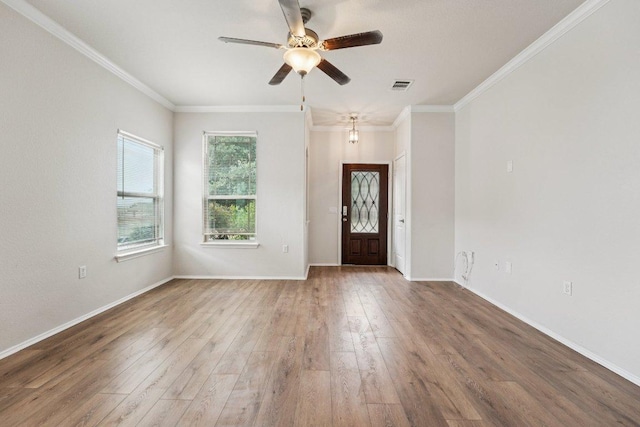 10017 Pinnacle Crest Loop, Austin, TX 78747 - foyer with wood finished floors, ceiling fan, baseboards, and crown molding