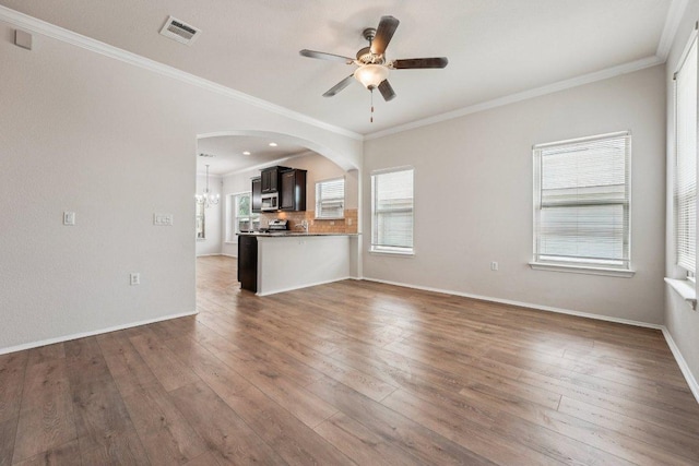 10017 Pinnacle Crest Loop, Austin, TX 78747 - unfurnished living room with ceiling fan, hardwood / wood-style flooring, arched walkways, ornamental molding, and baseboards