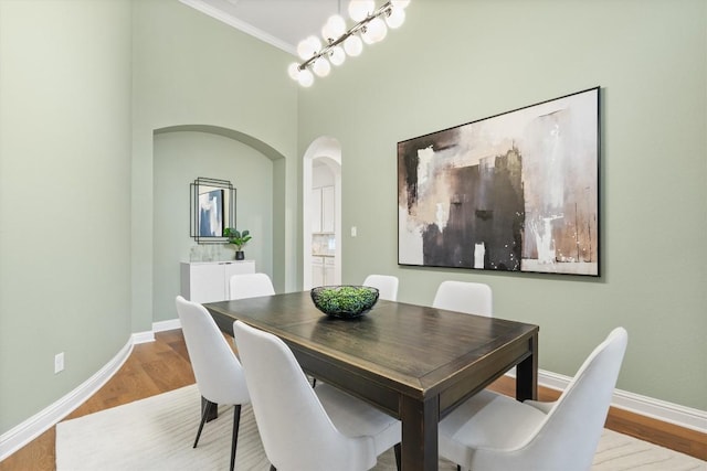 dining area featuring hardwood / wood-style flooring and ornamental molding