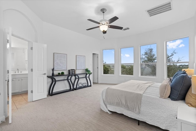 carpeted bedroom featuring connected bathroom, sink, and ceiling fan