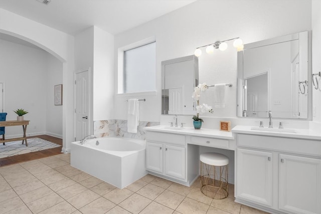 bathroom featuring vanity, a tub, and tile patterned floors