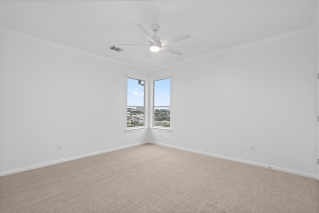 empty room with crown molding, light carpet, and ceiling fan