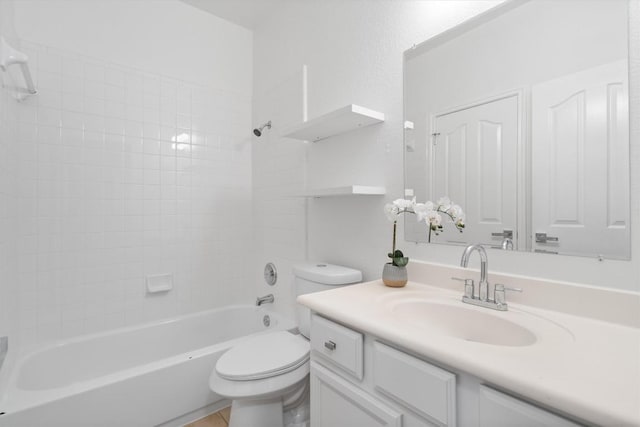 full bathroom with vanity, tiled shower / bath, and toilet