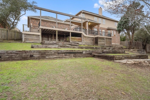 back of house with a yard and a deck