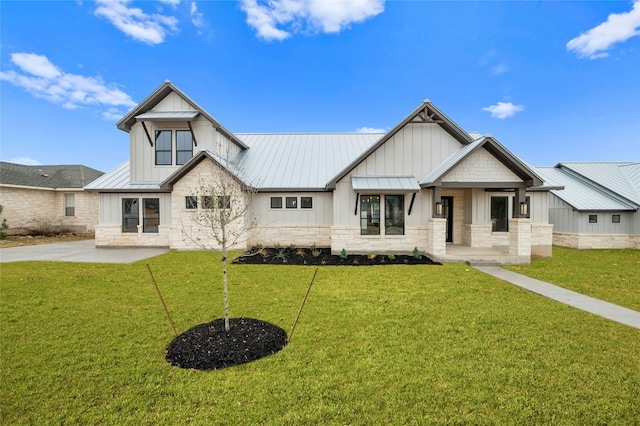 modern inspired farmhouse featuring a standing seam roof and stone siding