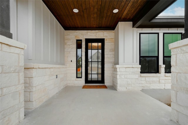 entrance to property featuring stone siding