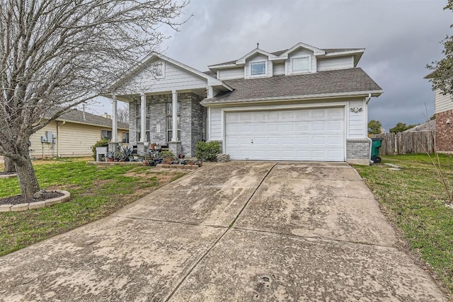 view of front facade featuring a garage, a front yard, and a porch