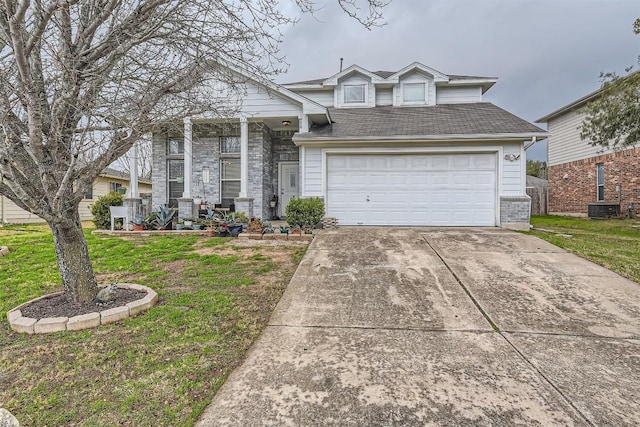 view of front of property with a garage, central AC, and a front yard